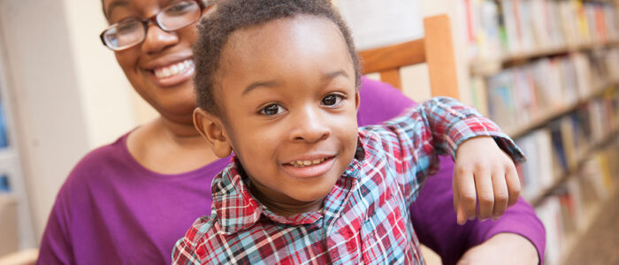 Boy and his mother smiling