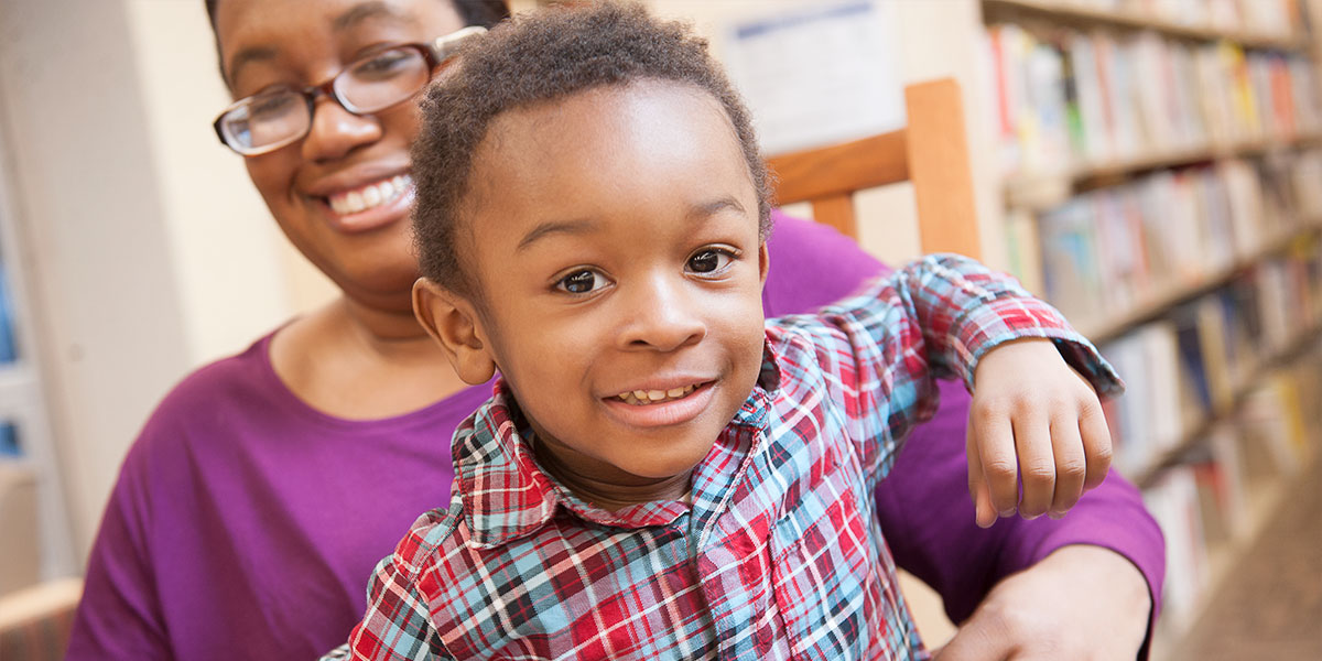 Boy and his mother smiling