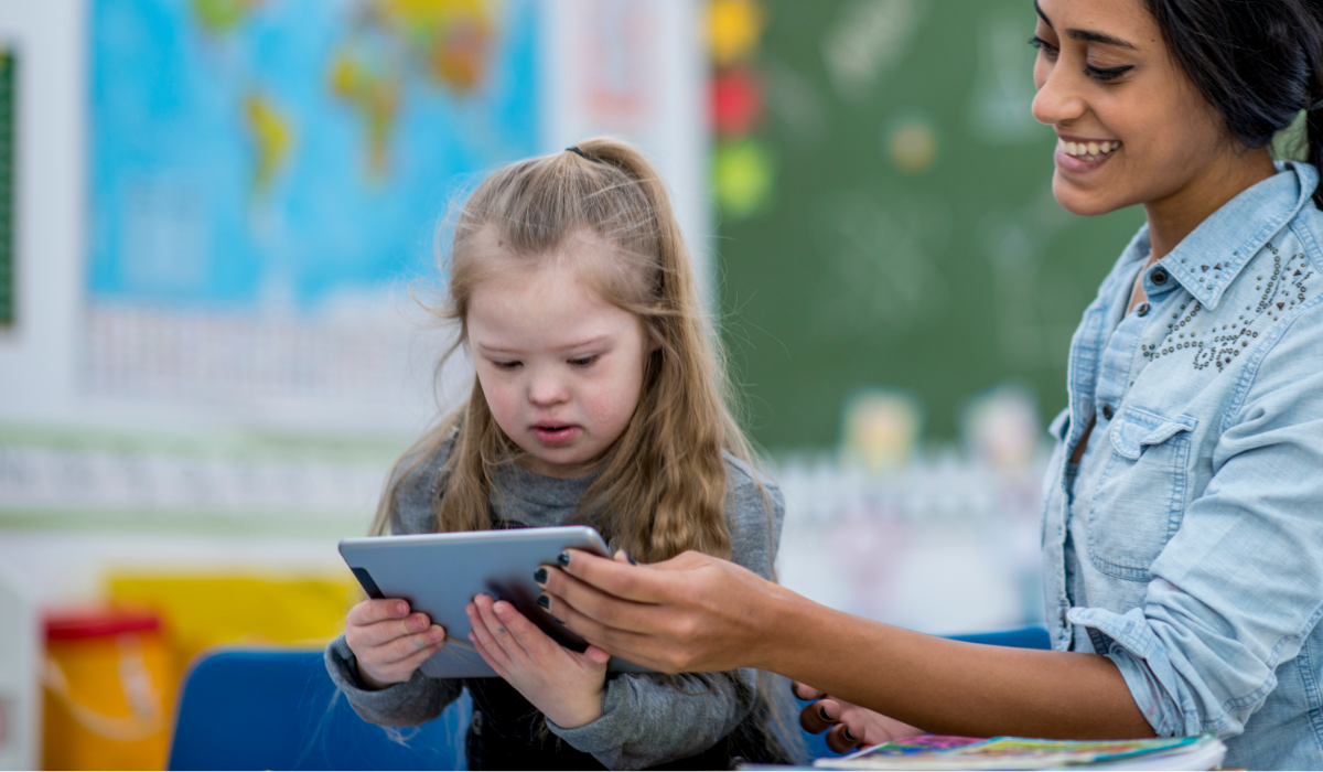 teacher and little girl w/ AT ipad device