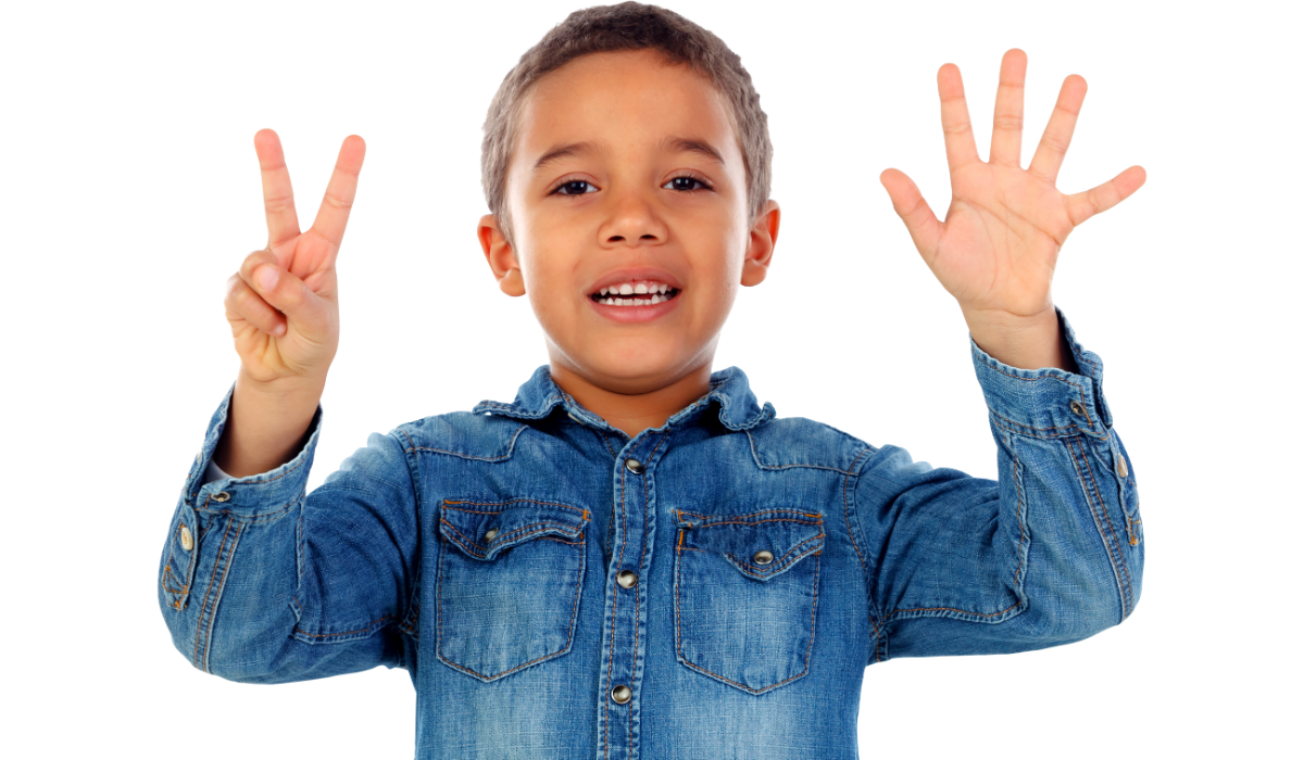 boy about 6 years old, smiling, holding up seven fingers