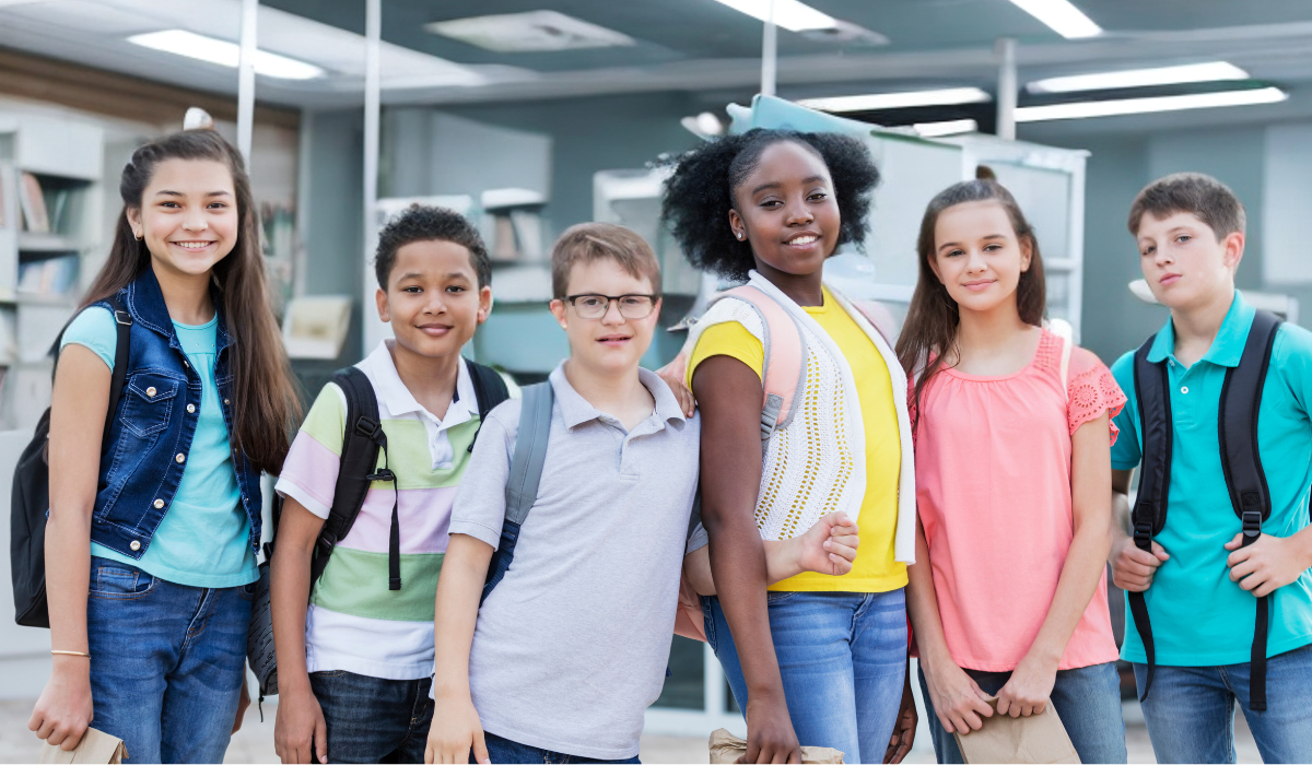 group of middle school students in the hallway at school, one has Down Syndrome