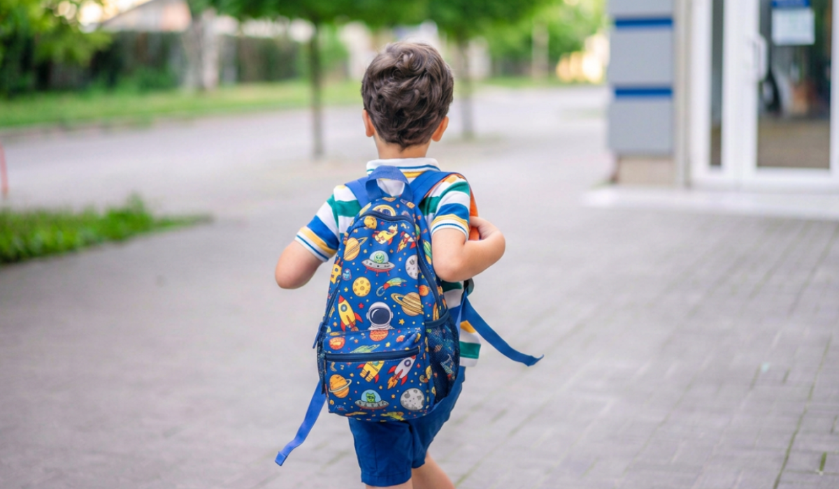 preschooler with a backpack walking into school