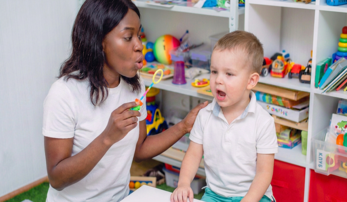young child and speech therapist with bubbles